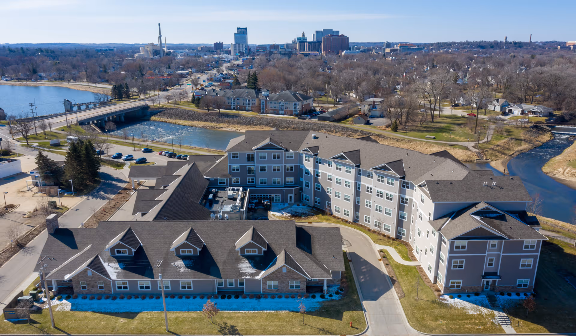 Aerial view of Savannah Cottage of Oviedo senior living campus near a river.