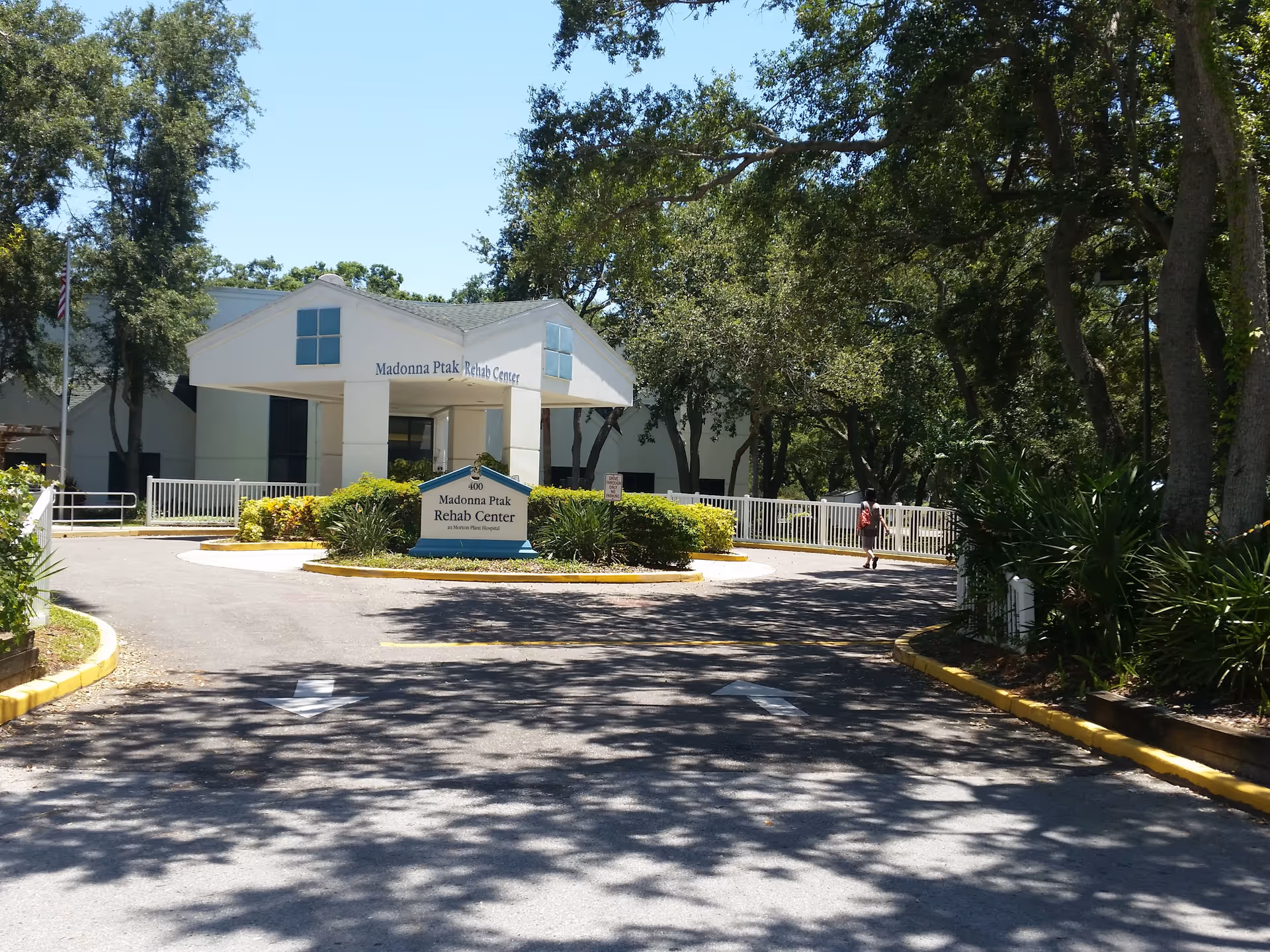 Front view of Madonna Ptak Rehab Center entrance with a circular driveway and trees