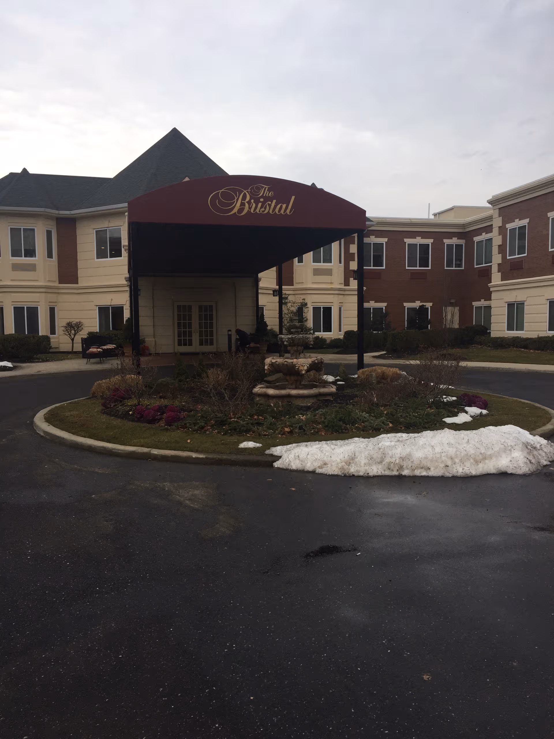 The Bristal assisted living entrance with curved driveway and landscaping.