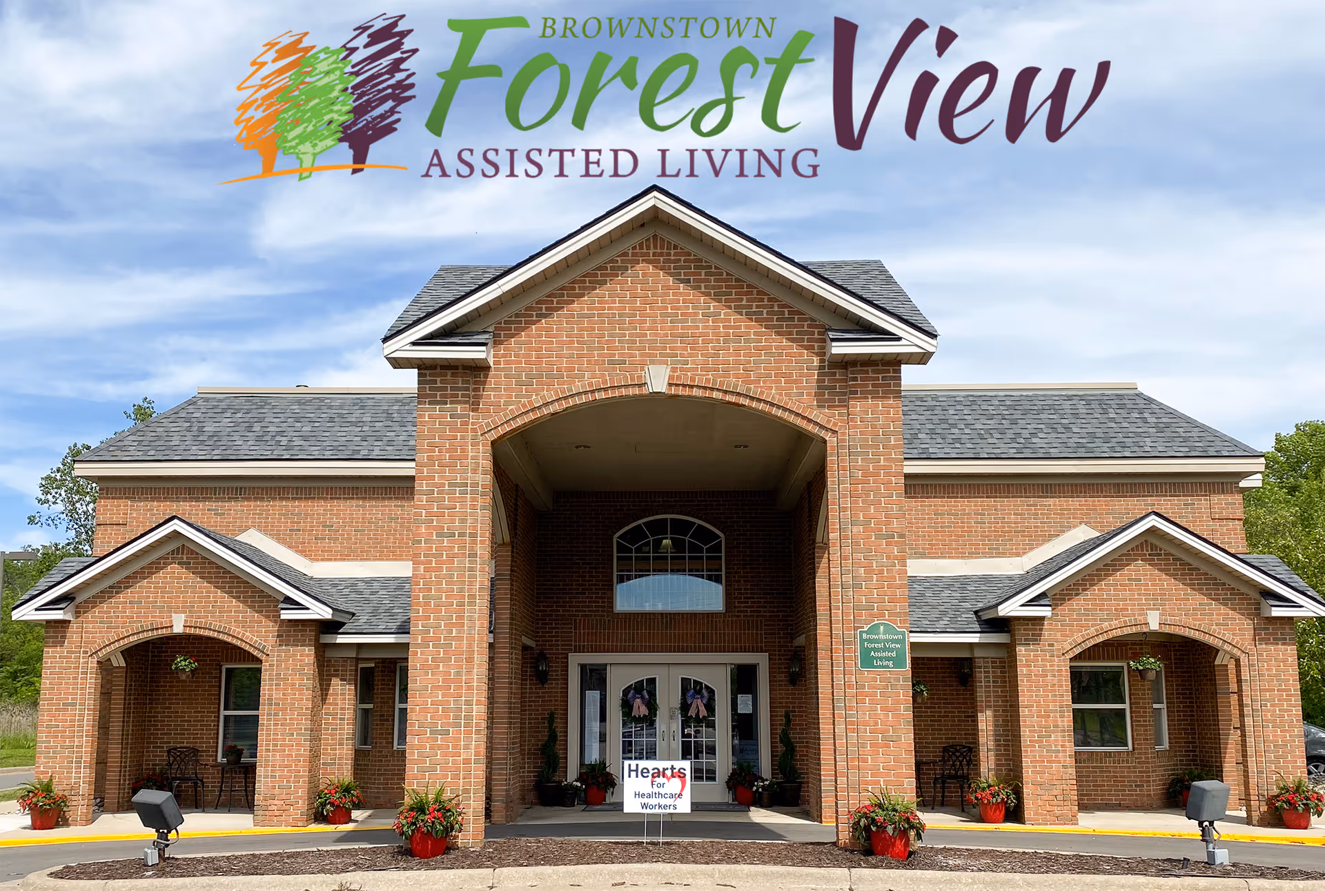 Brick building with arched entrance and Brownstown Forest View Assisted Living signage.