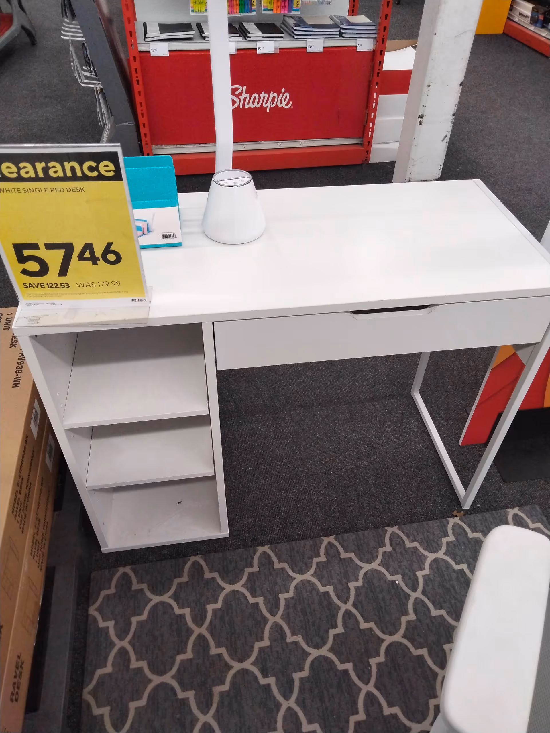 White desk with built in shelves in a store, price tag and Sharpie display visible.