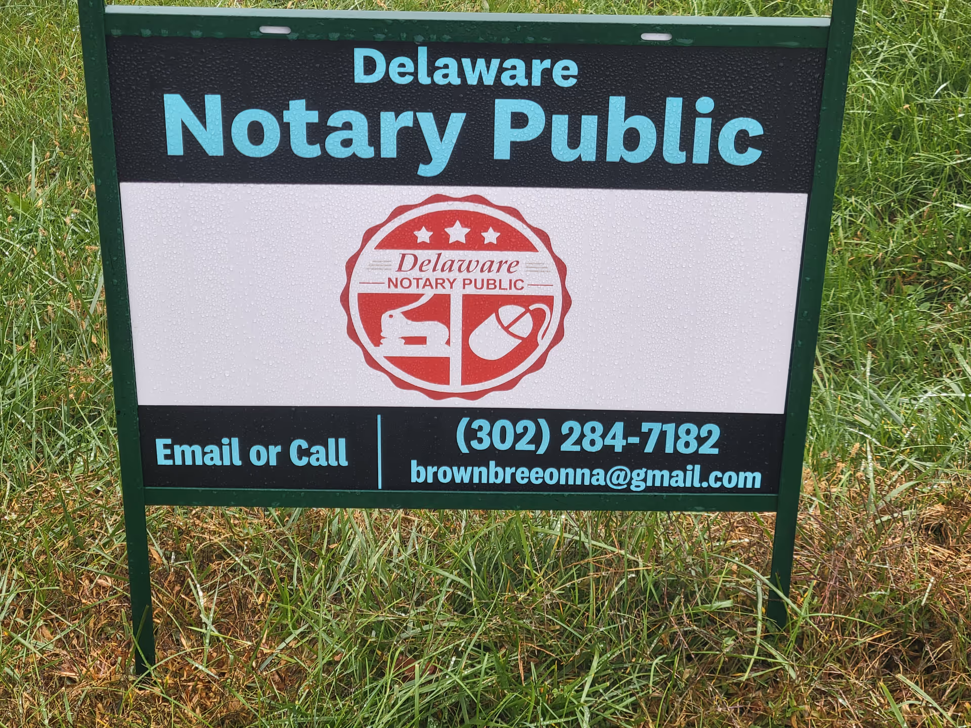 Delaware Notary Public sign on a grassy lawn