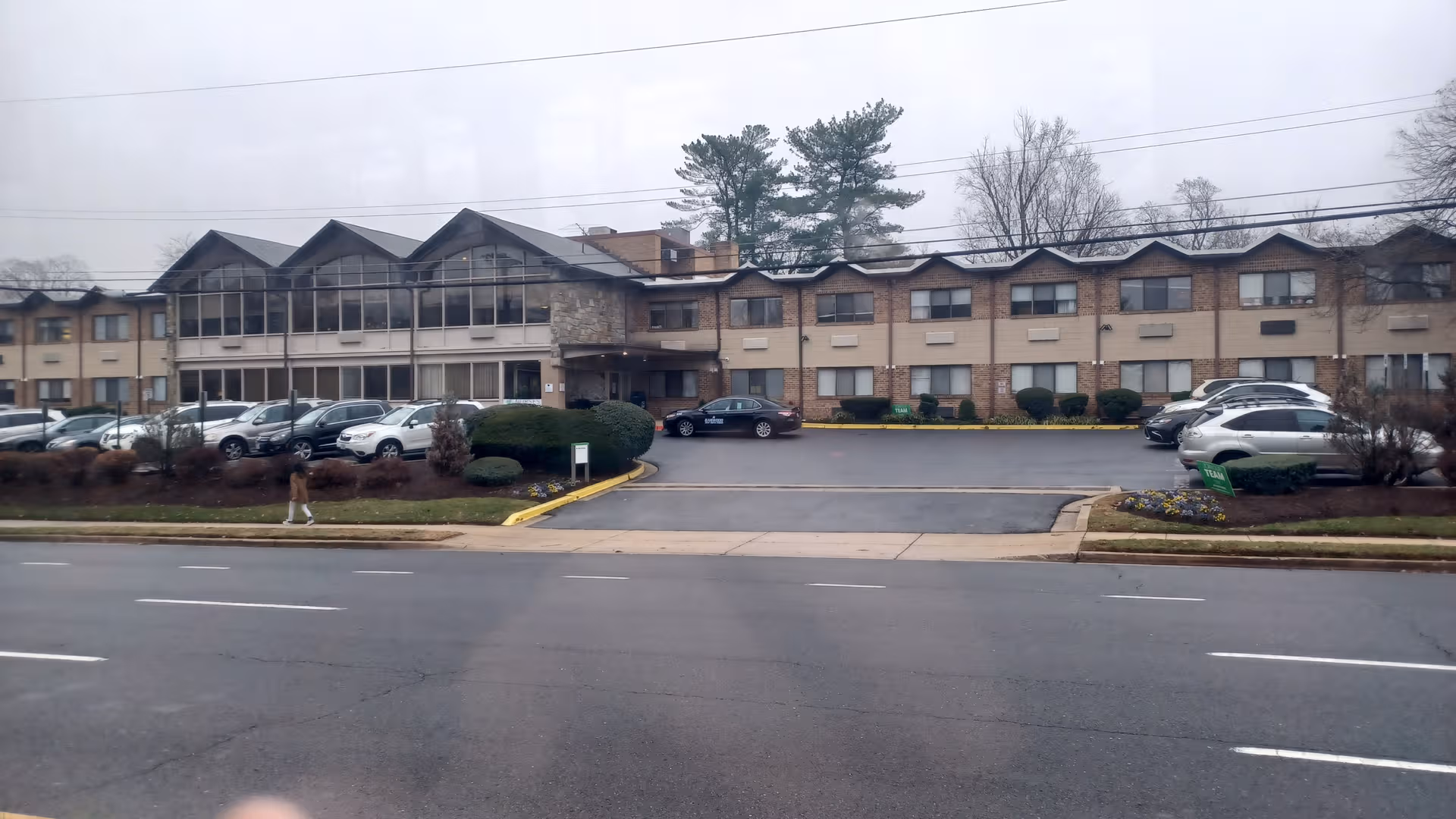 Exterior view of Montcare Bethesda facility with parking lot, entrance, and surrounding trees.