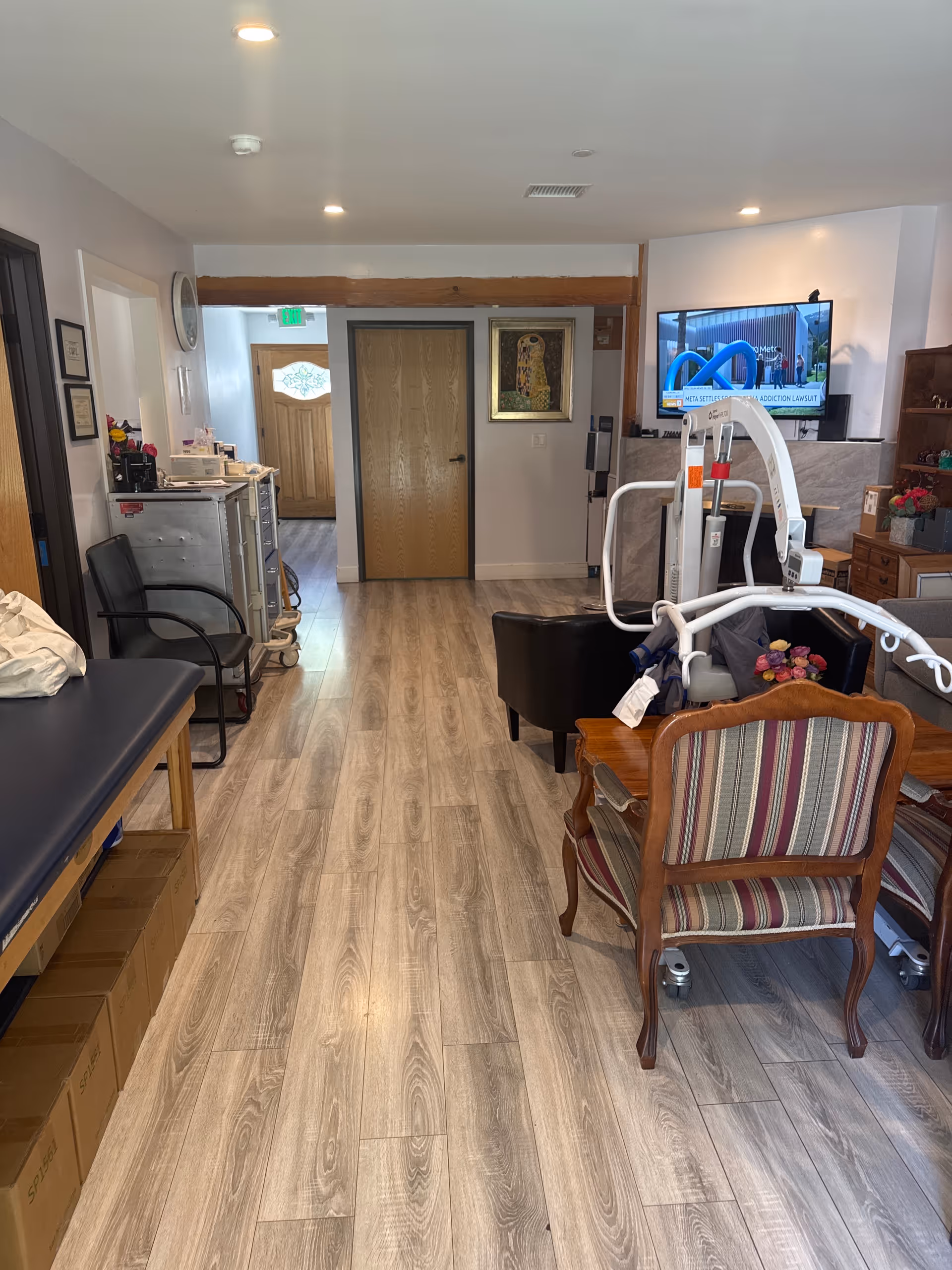 Interior view of a senior living facility common area with medical equipment and seating.