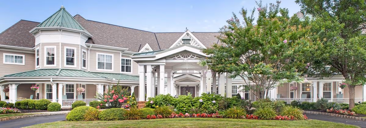 Sunrise of Wall exterior building with landscaped entrance and welcoming covered walkway.
