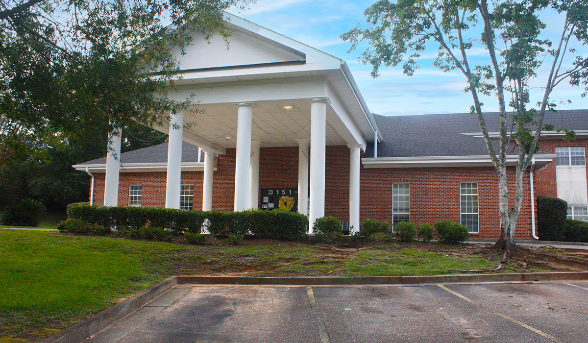 Brick healthcare center building with white columns and a covered entrance.