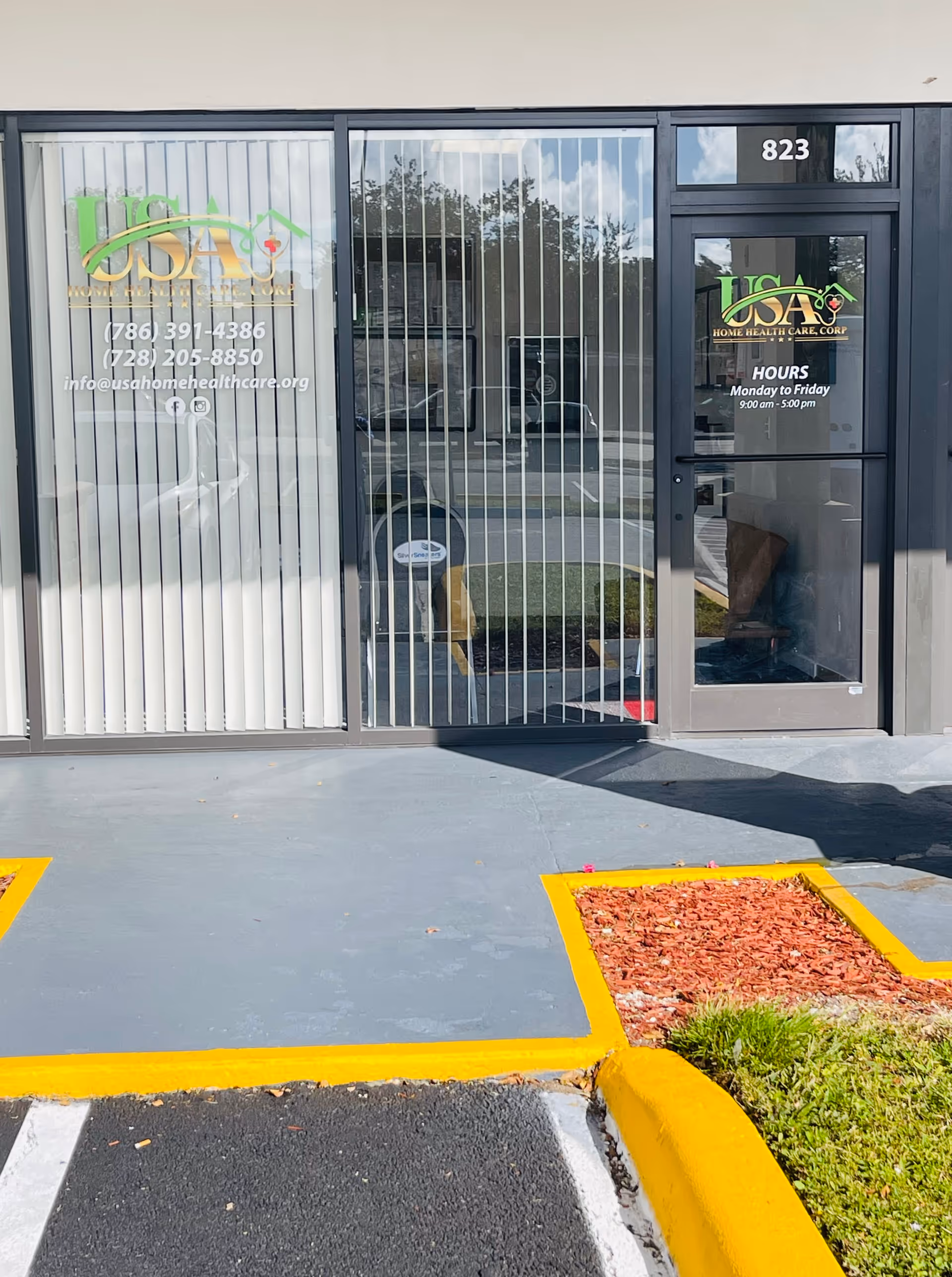 Glass storefront entrance for USA Home Health Care Corp with blinds and signage