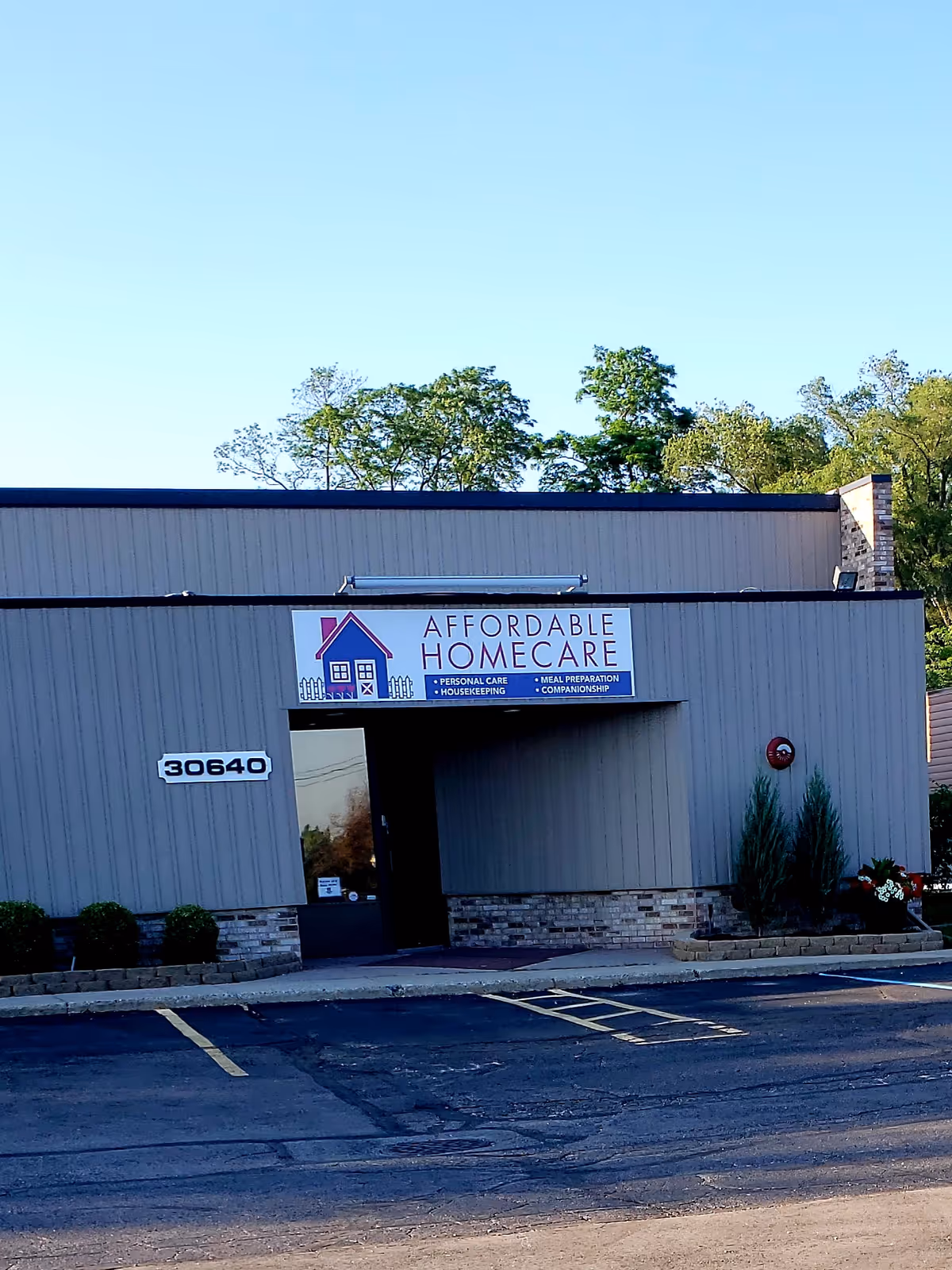 Exterior view of Affordable HomeCare facility storefront with sign and parking lot.