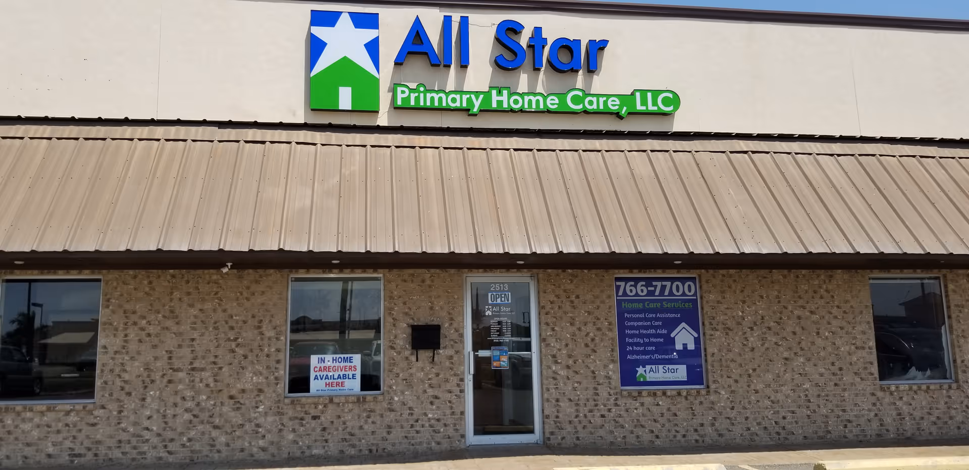 Brick exterior of an All Star Primary Home Care facility with blue and green signage.
