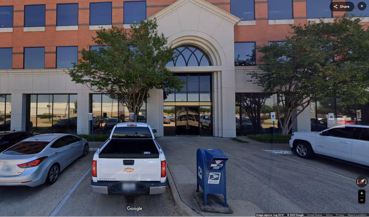 Exterior view of Sunrise facility front entrance with parked cars and trees