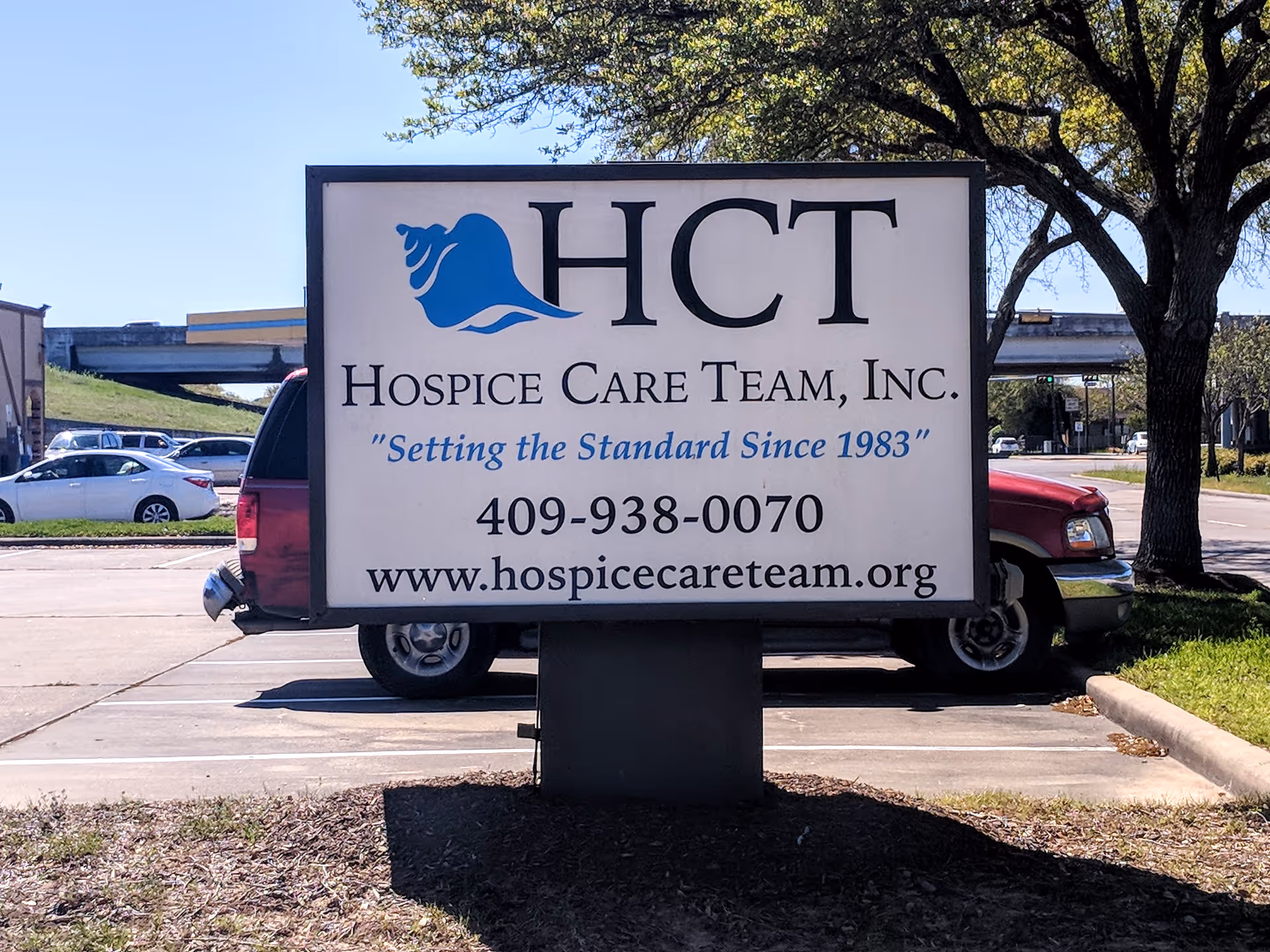 Large outdoor sign for Hospice Care Team, Inc. in a parking lot.