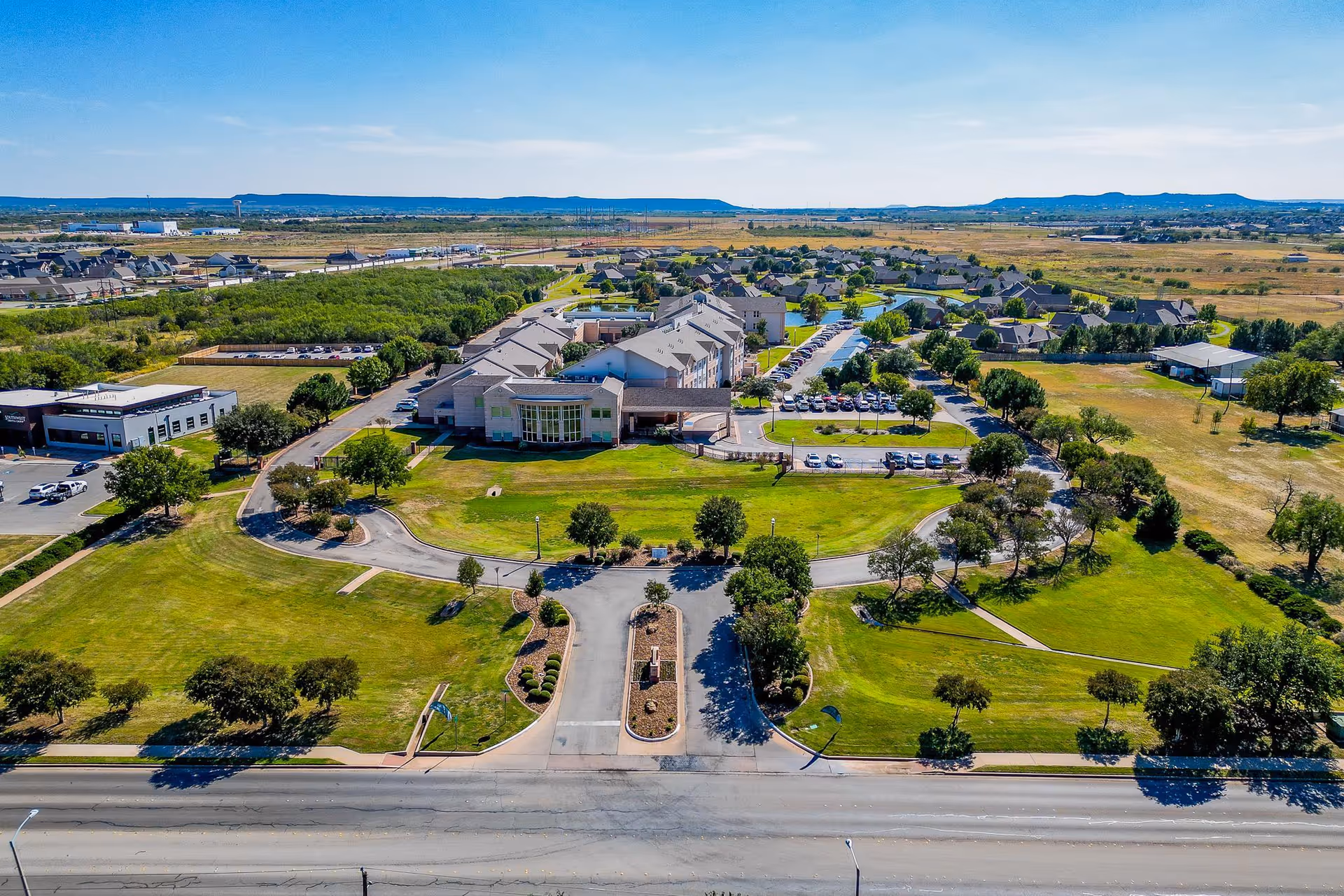 Aerial view of Wesley Court senior living campus with circular driveway and green lawns