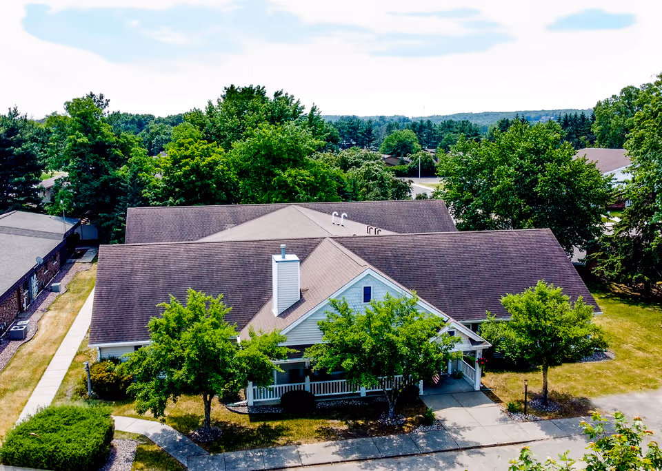 Aerial view of Our House Senior Living Eau Claire Memory Care building with surrounding trees.