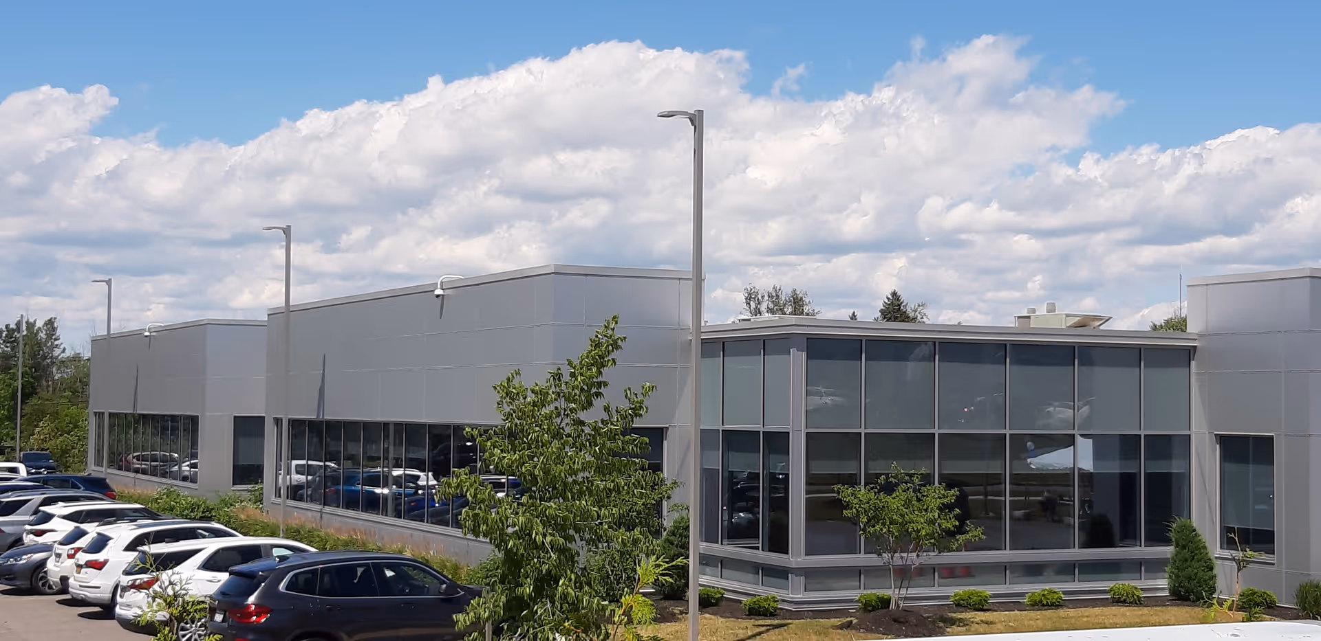 Exterior view of VNA of WNY facility with glass walls and cars.