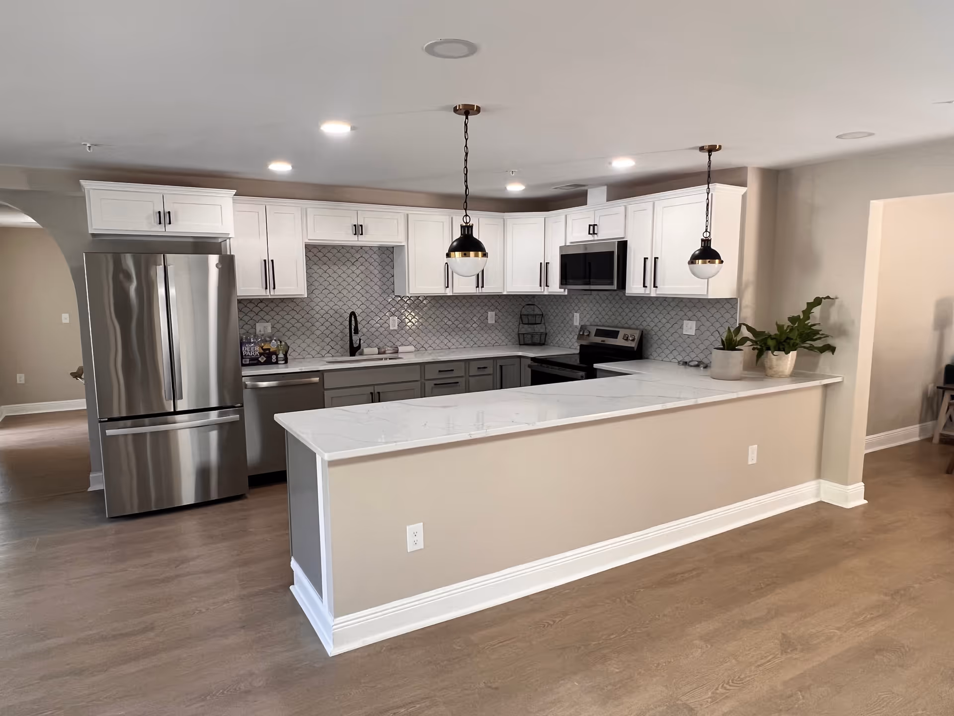 Modern kitchen in a senior living facility with white cabinets and stainless appliances.