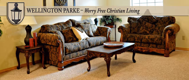 Cozy living room with two patterned sofas, a wooden coffee table, and side tables.