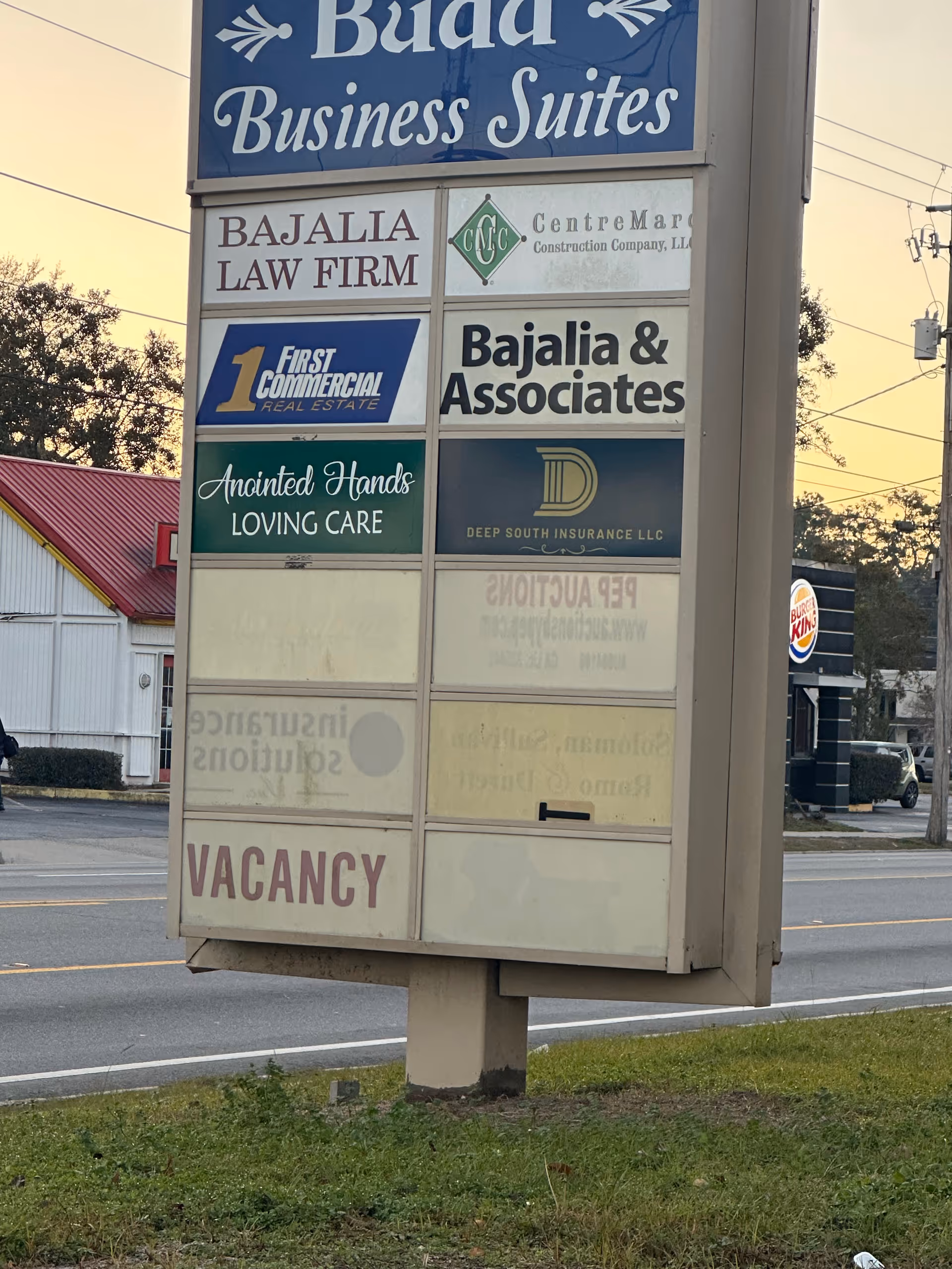 Tall outdoor signboard displaying multiple business names including Anointed Hands Loving Care.
