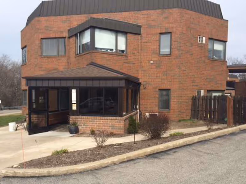 Parma Care Center exterior with glass-entry foyer and parking.