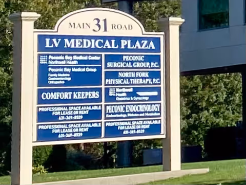 Outdoor blue and white signboard for LV Medical Plaza and Comfort Keepers in Riverhead, NY.