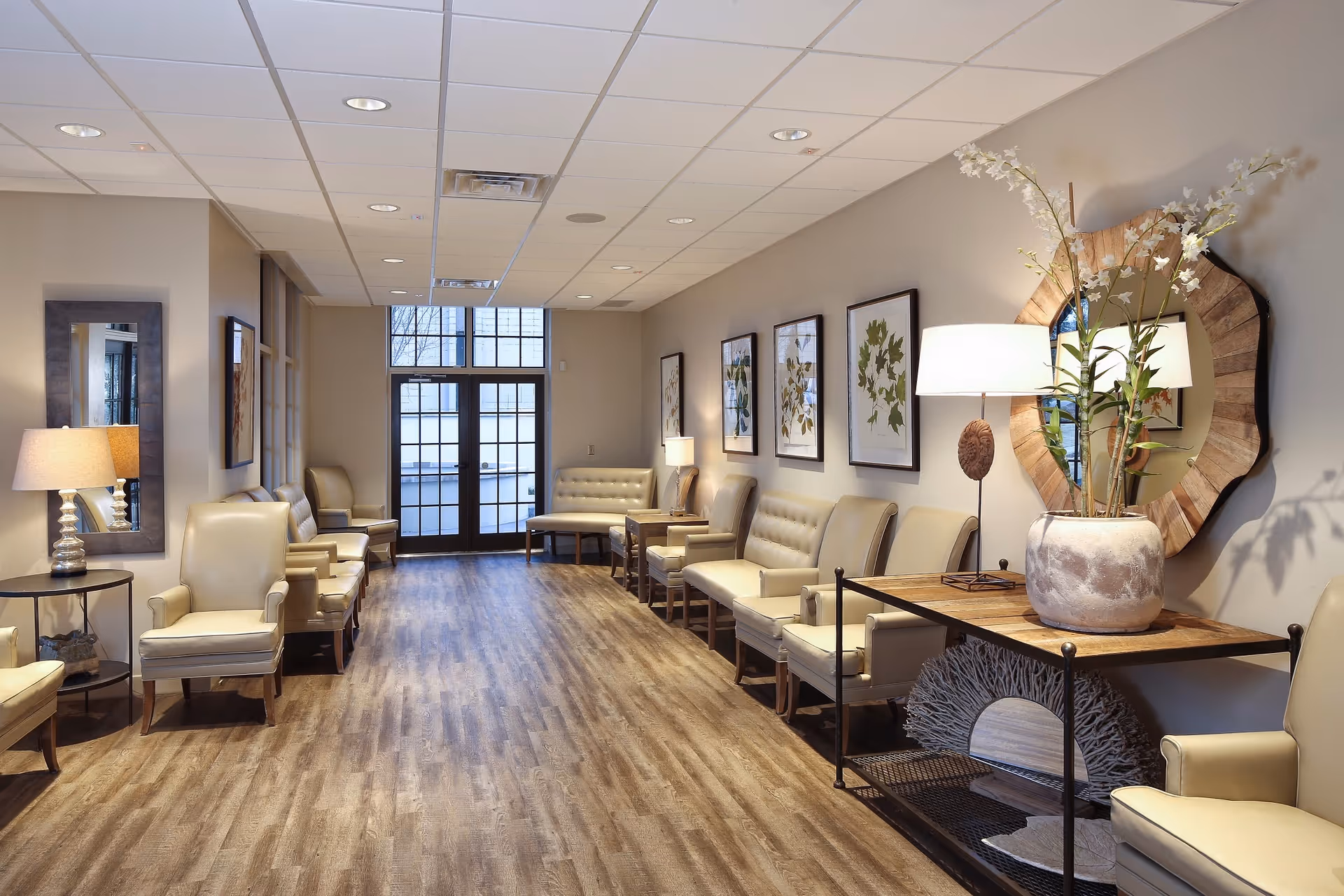Interior senior living lounge with beige seating and wall art.