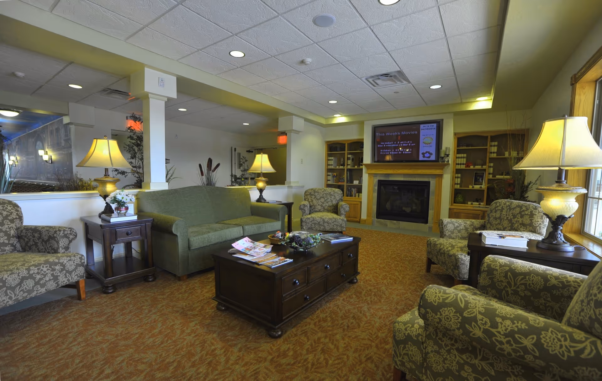 A spacious Stillwater Primrose living room with couches, lamps, and a fireplace.