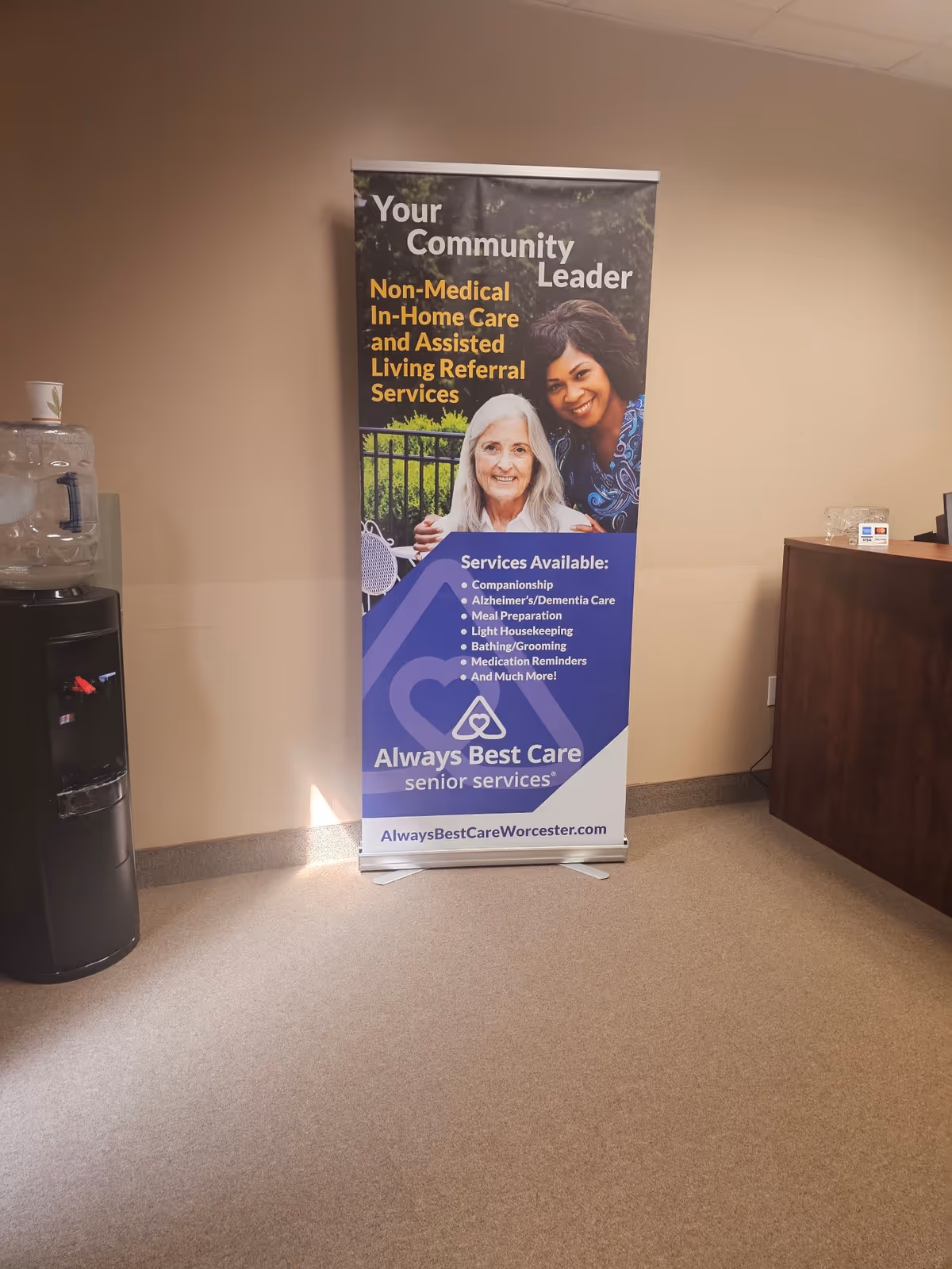 Indoor lobby with Always Best Care banner and water cooler in Worcester facility.