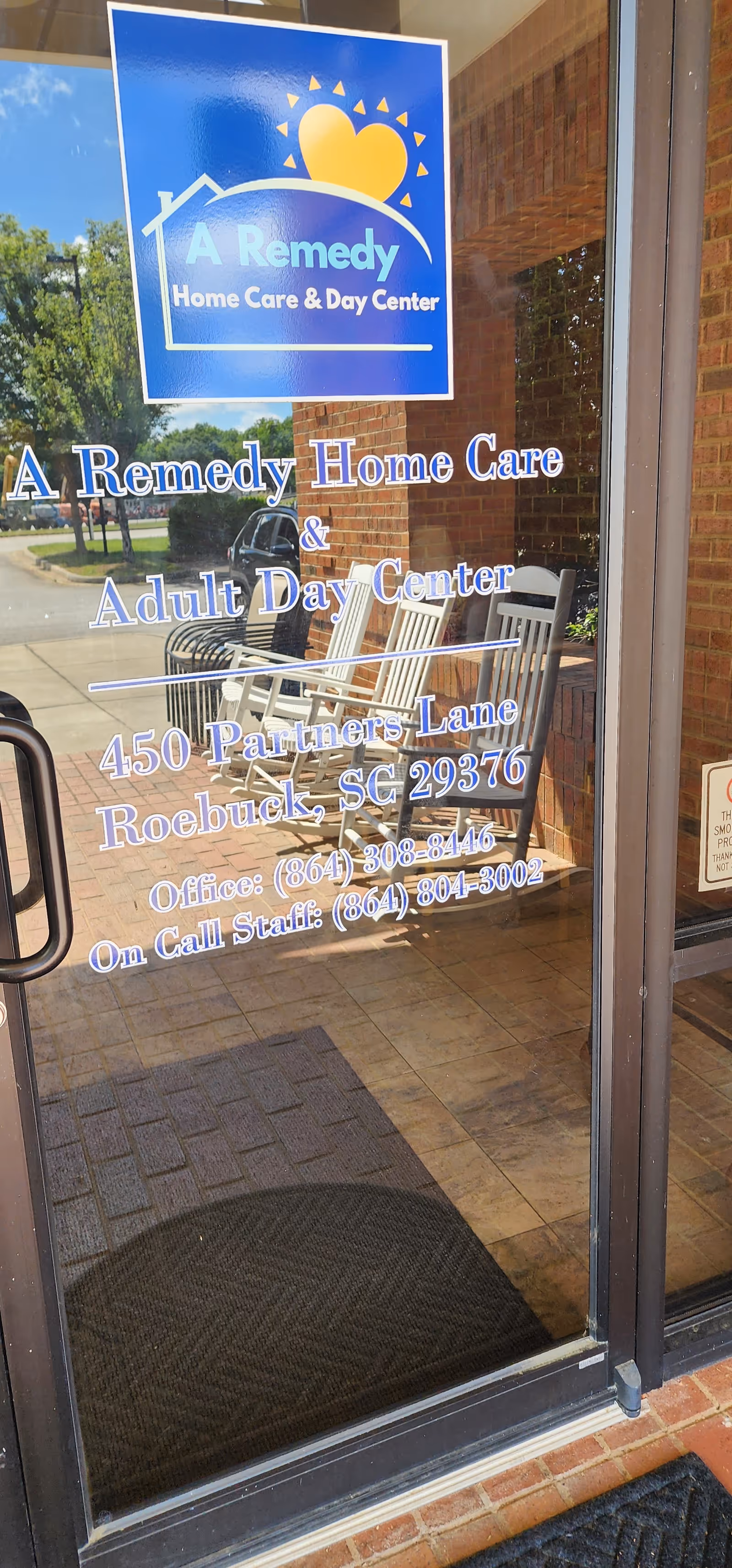 Glass entrance door shows A Remedy Home Care and Day Center sign with chairs visible inside.