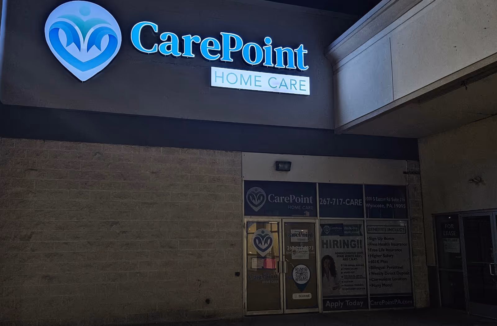 CarePoint Home Care storefront with illuminated sign and glass entrance doors.