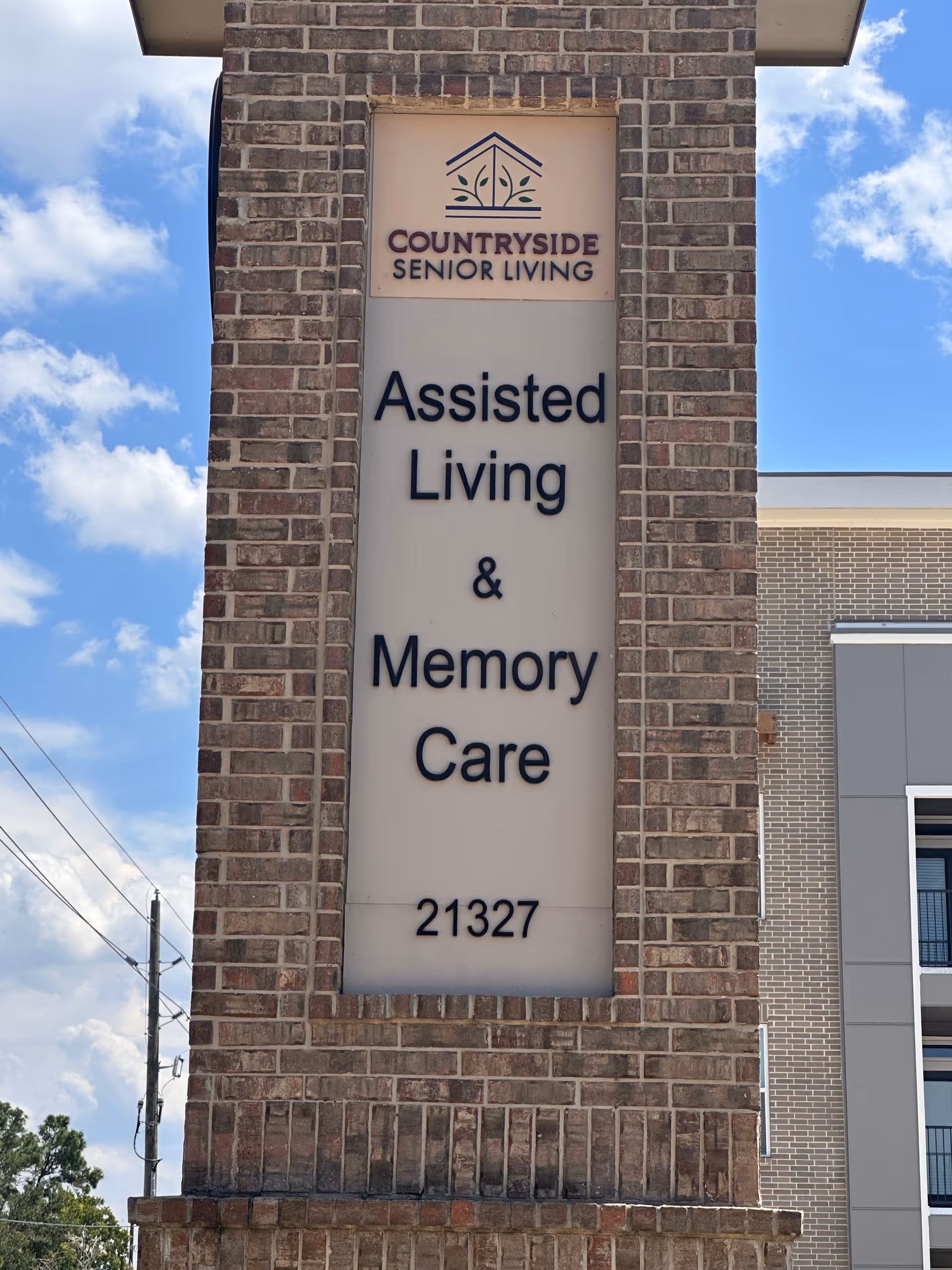 Brick sign pillar shows Countryside Senior Living and Assisted Living & Memory Care outside.