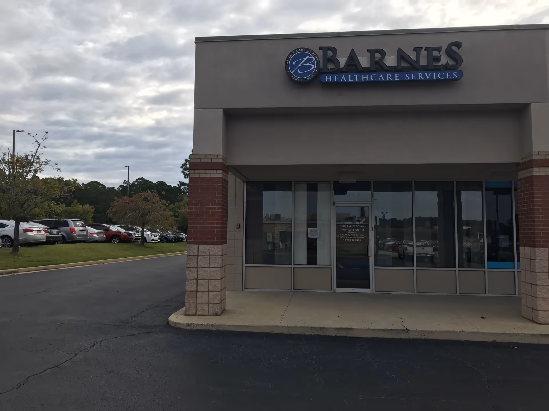 Exterior view of Barnes Healthcare Services storefront with parking lot in front.