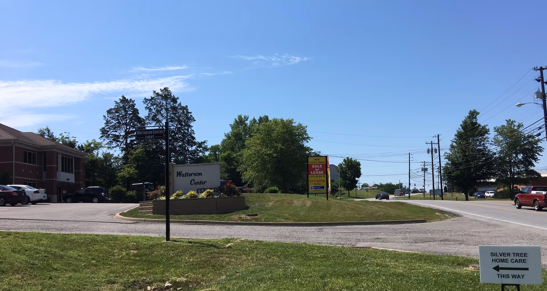 Outdoor roundabout with signage including Silver Tree Home Care.