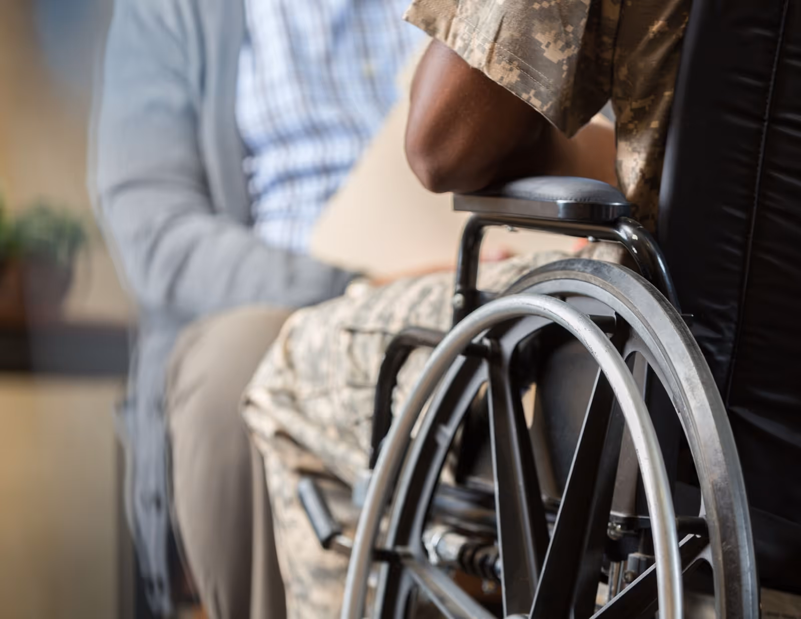 Close-up of a wheelchair in an indoor senior care setting.