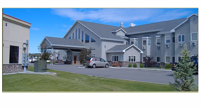 Front exterior view of Autumn Springs Assisted Living with parking and entrance.