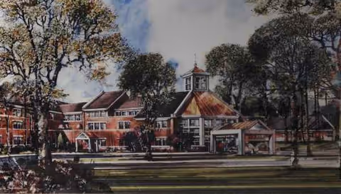 Exterior view of a brick senior living facility with trees and a front entrance.