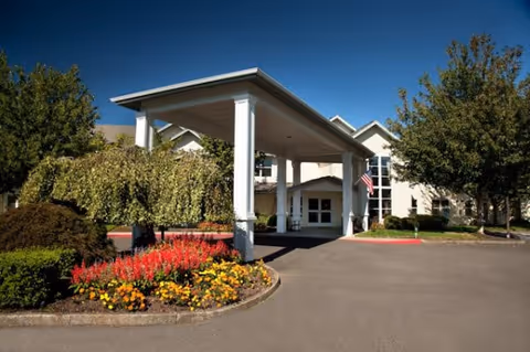 Exterior view of Diamond Care AFC facility with a covered entrance and landscaped surroundings