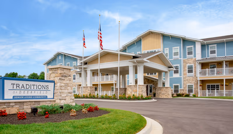 Exterior view of Traditions of Deerfield senior living center with entrance canopy