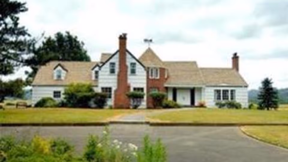 The Gulke Manor Afh LLC exterior shows a white, house-style senior living facility with brick chimneys.