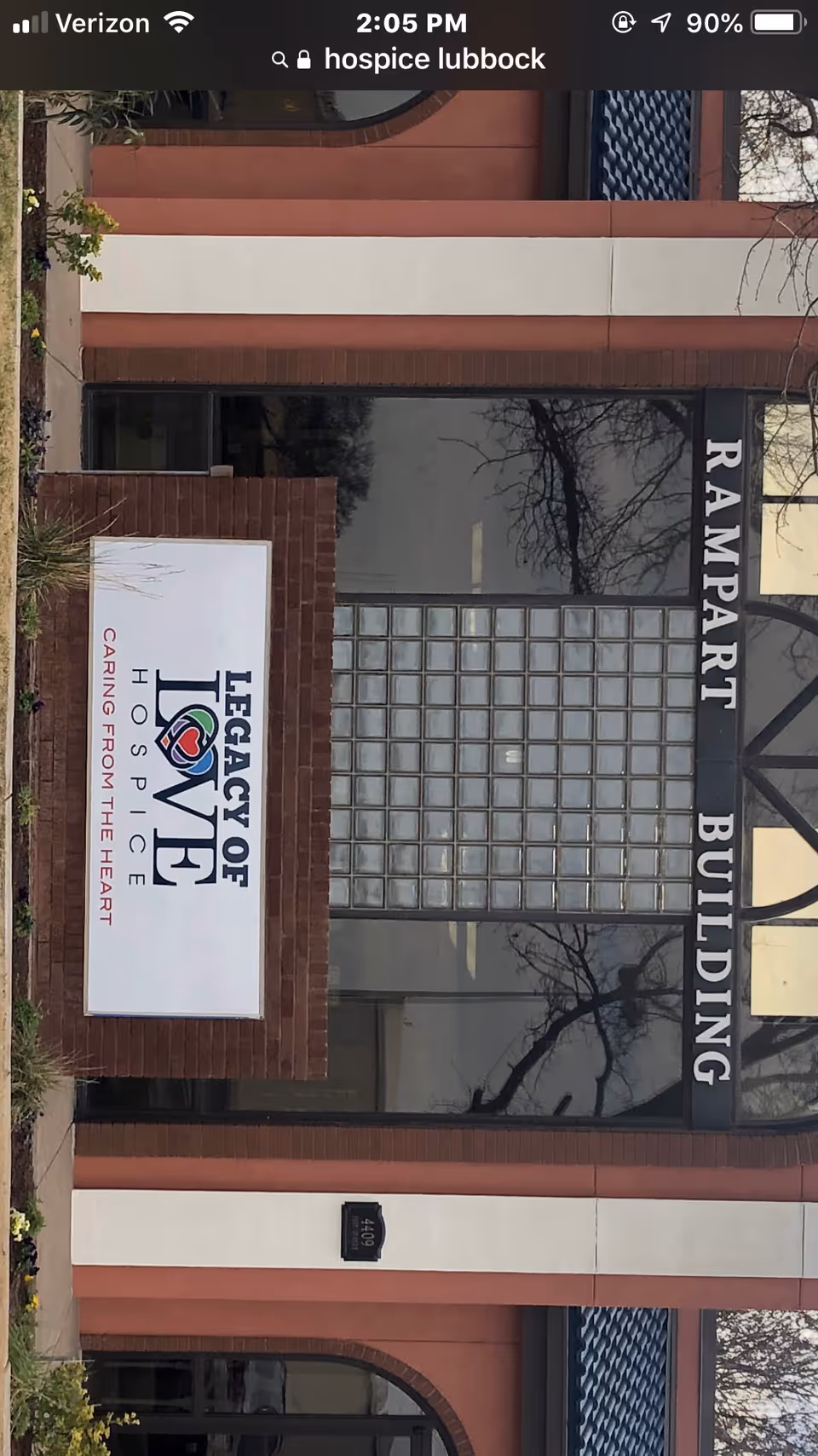 Exterior view of a brick building front with a Legacy of Hope Hospice sign.