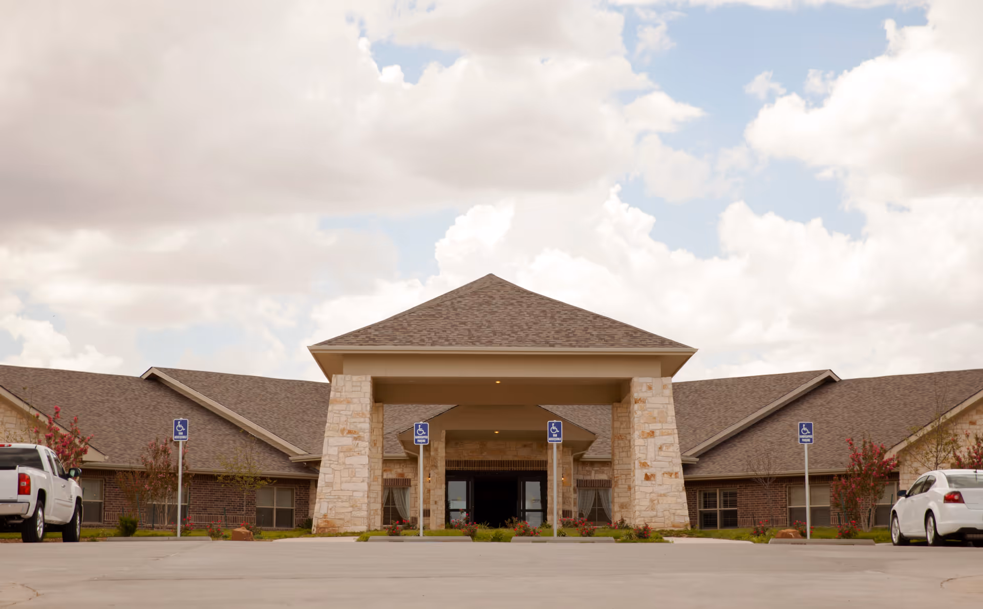 Front entrance of Hillside Heights Rehabilitation Suites with stone pillars and a porte-cochere.