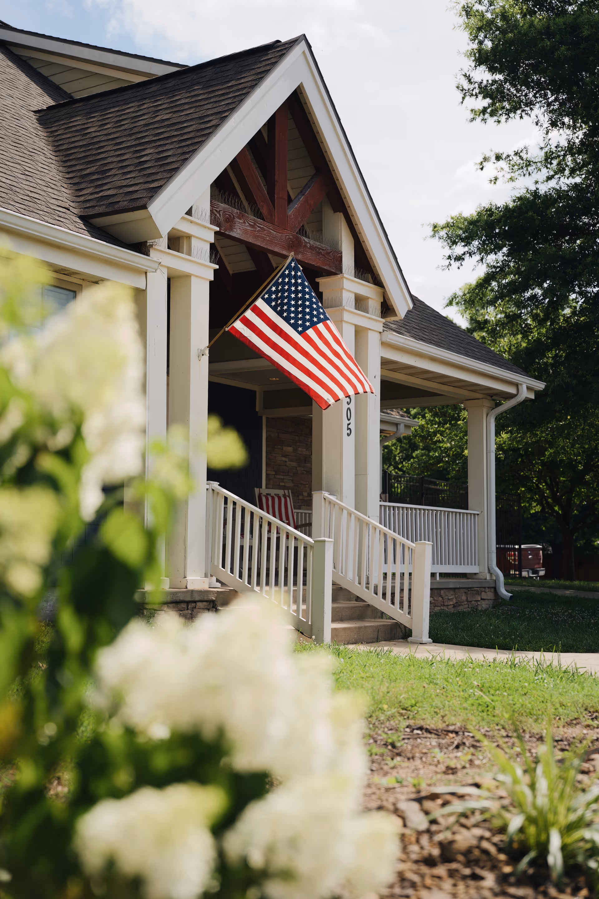Front entrance of a residential building with an American flag