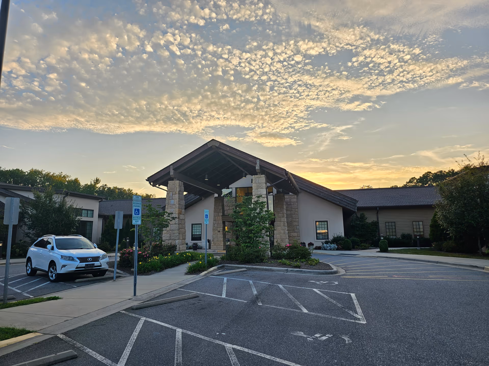 Asbury Health and Rehabilitation Center exterior with covered entrance, parking lot, and landscaped walkway.