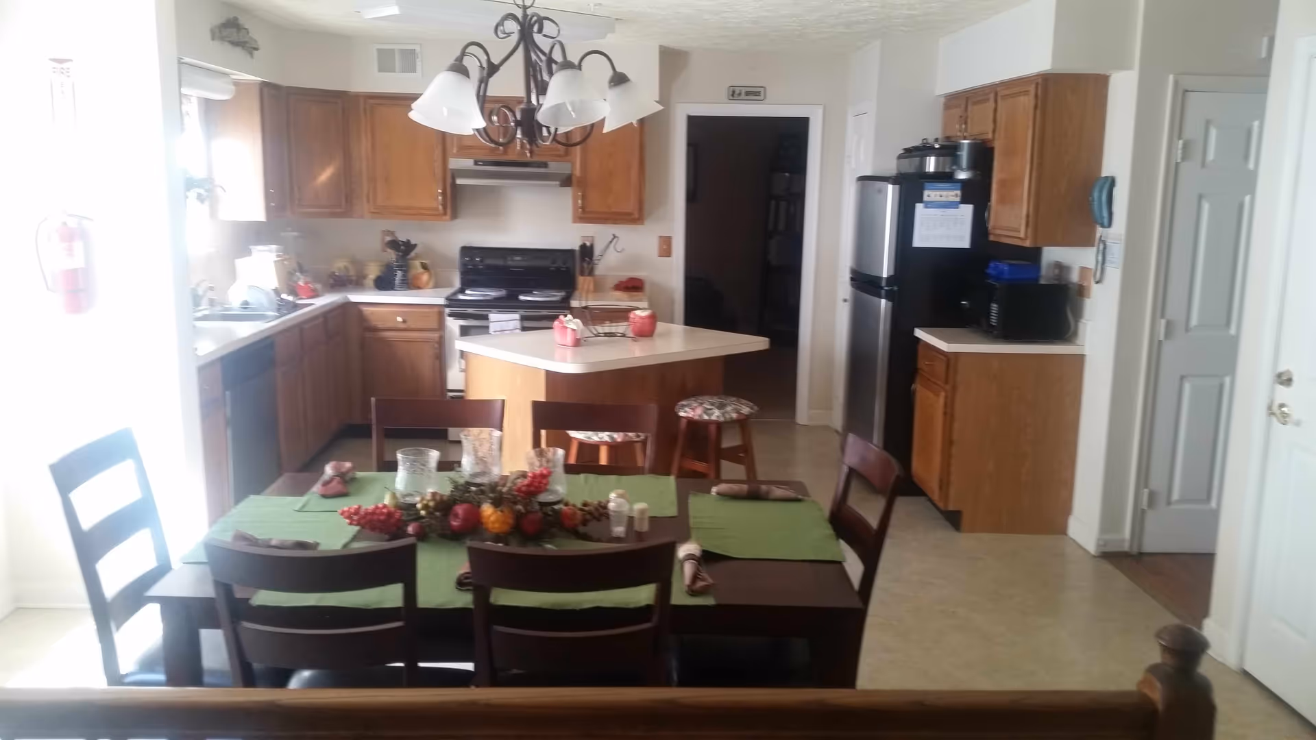 Interior of a senior living kitchen and dining area with a central island.