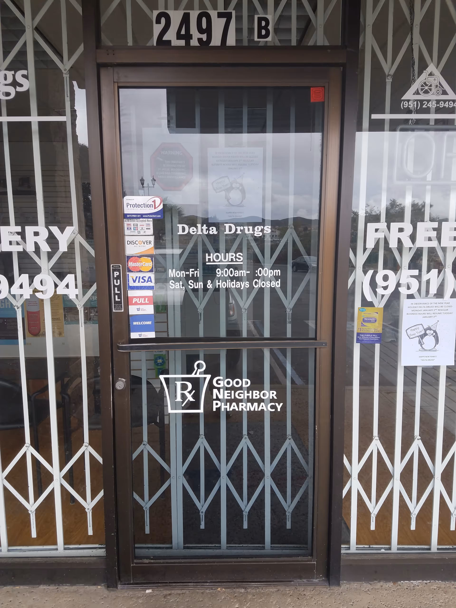 Front entrance of Delta Drugs & Medical Supplies with security bars and signage.