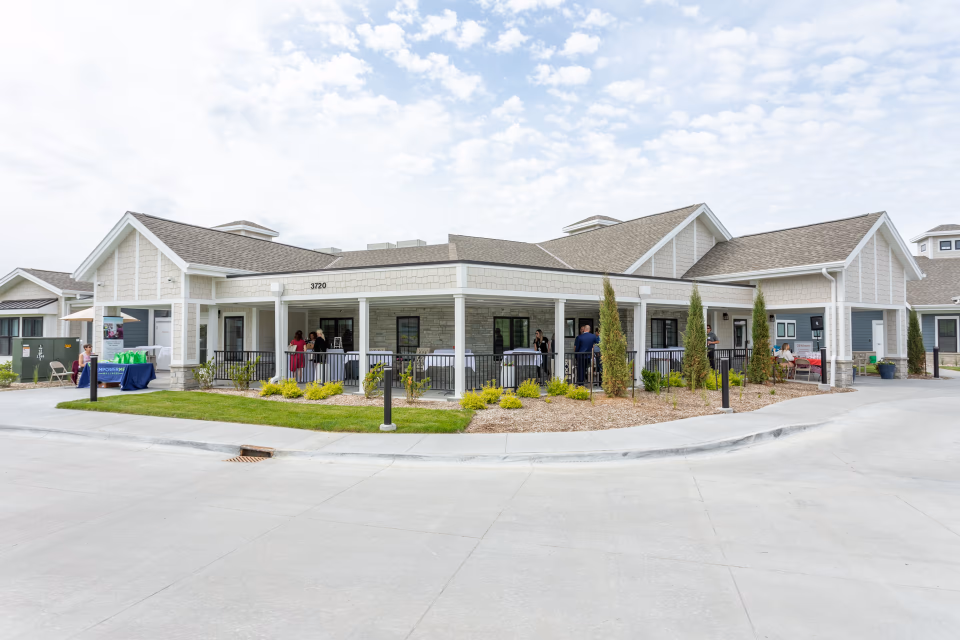 Exterior view of CountryHouse Residence showing a covered front porch with residents.