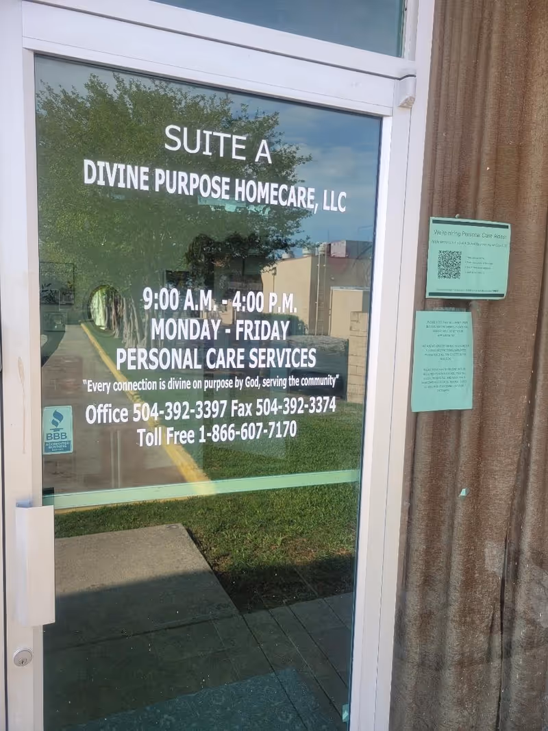 Glass door displays 'Suite A Divine Purpose Homecare, LLC' with hours and services.