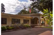 Seaside Health and Rehabilitation Center exterior with flagpole and landscaped entrance.