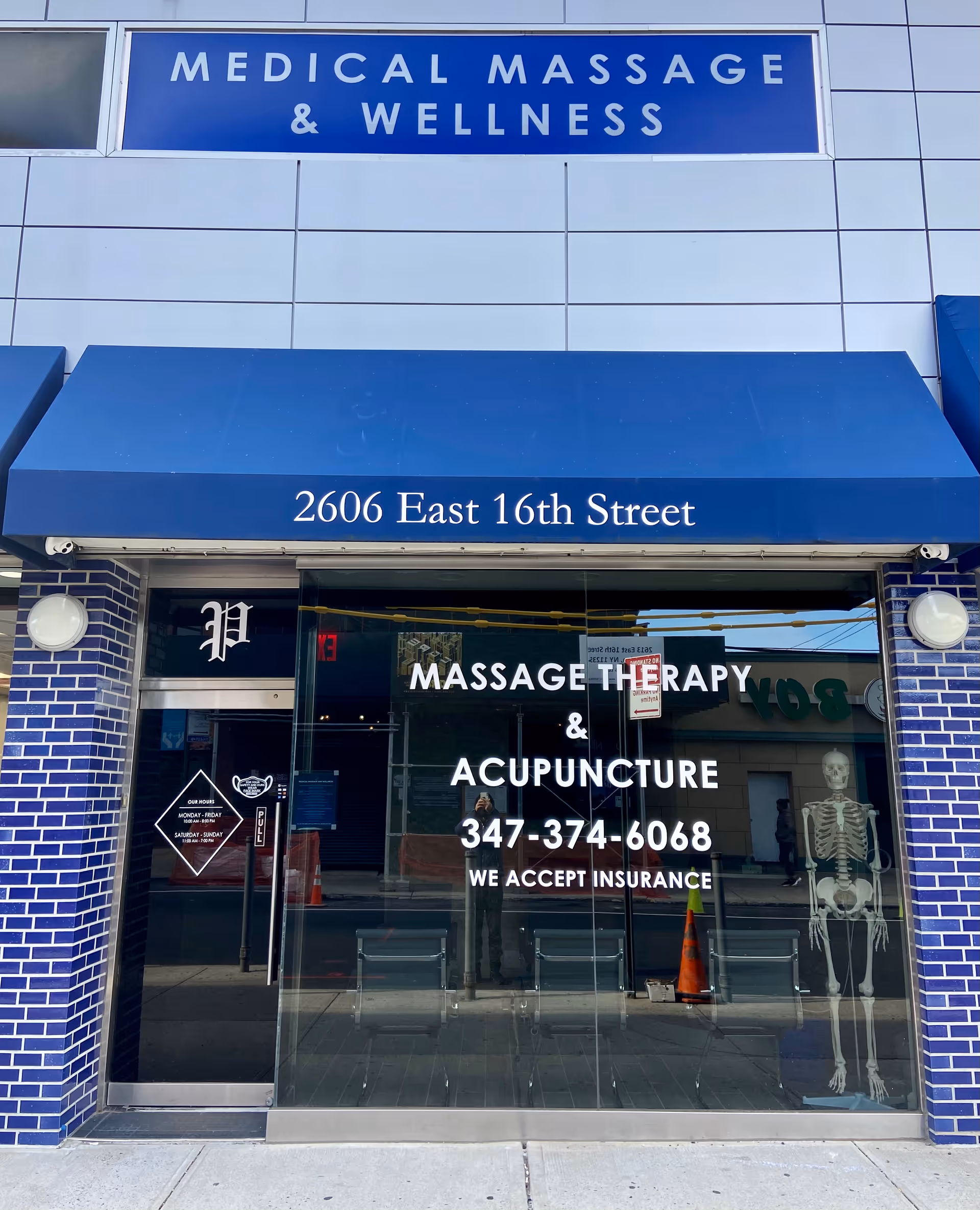 Blue storefront with Medical Massage & Wellness sign and glass entrance.