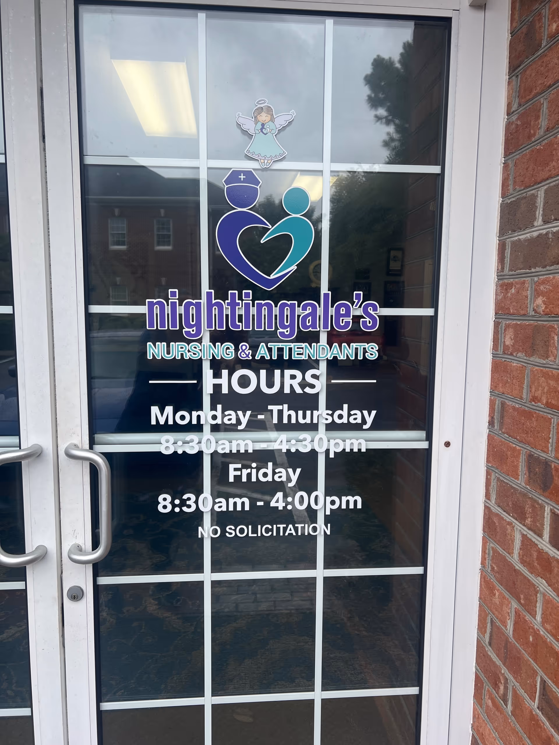 Glass front door shows Nightingale's Nursing & Attendants logo and hours; brick exterior.