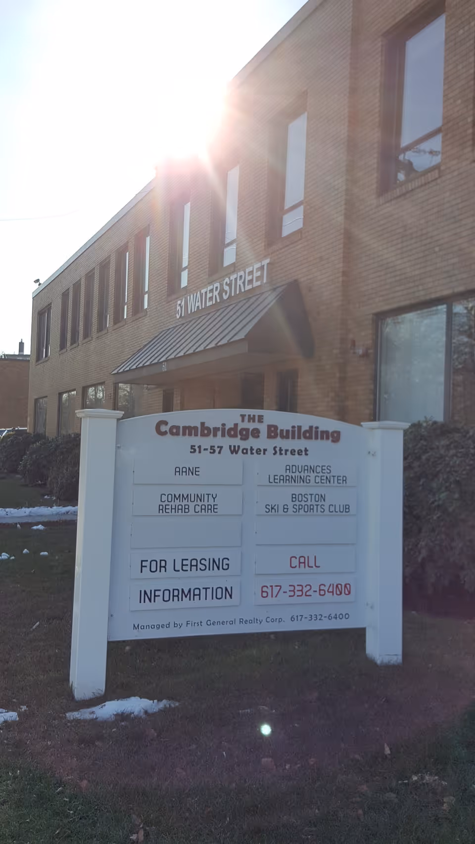 Brick building exterior with The Cambridge Building sign at 51 Water Street