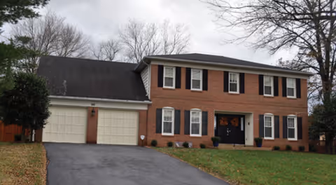 Brick two-story Royals Assisted Living facility with double garage and manicured lawn.
